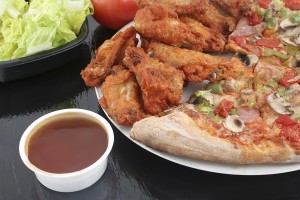 crispy chicken wings and ham pizza with red and green peppers, salad, and honey garlic dipping sauce